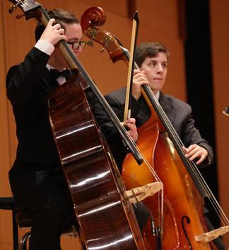 Strings ensemble members playing the cello